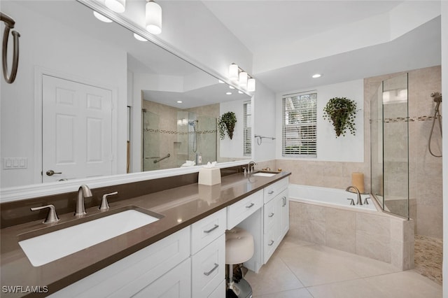 bathroom featuring tile patterned floors, plus walk in shower, and vanity