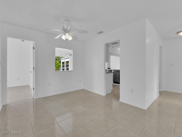 empty room with light tile patterned floors and ceiling fan