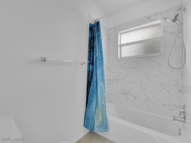 bathroom with shower / bath combo with shower curtain and tile patterned floors