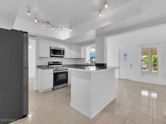 kitchen featuring white cabinets, light tile patterned floors, and appliances with stainless steel finishes