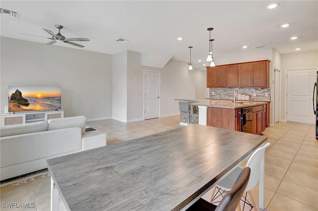 dining room with ceiling fan, sink, and light tile patterned floors