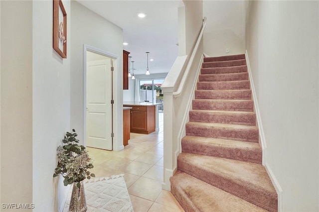 stairway with tile patterned flooring