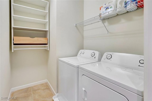 laundry room featuring washer and dryer and light tile patterned floors