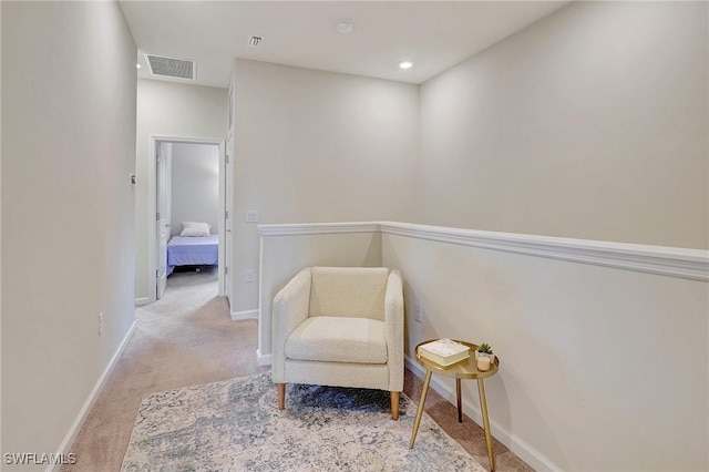 sitting room with light colored carpet