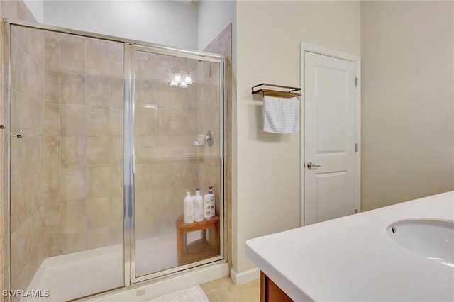 bathroom with vanity, an enclosed shower, and tile patterned flooring