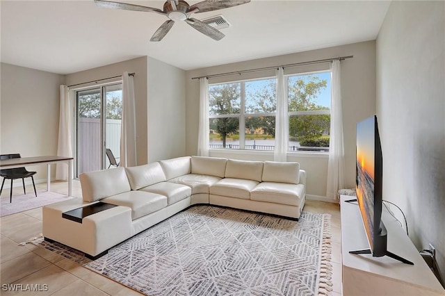 tiled living room with ceiling fan