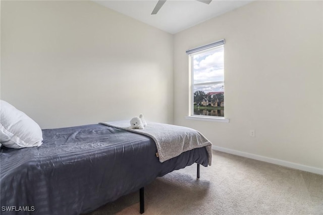 bedroom with lofted ceiling, ceiling fan, and carpet