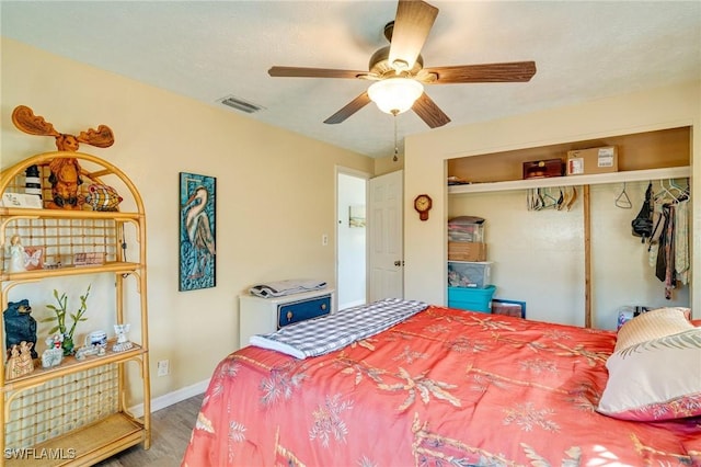 bedroom featuring hardwood / wood-style floors, a closet, and ceiling fan