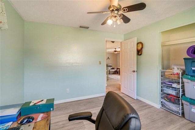 home office with light hardwood / wood-style flooring