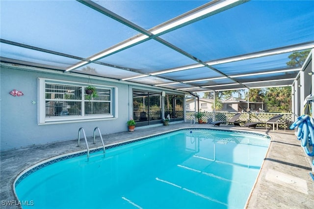 view of pool featuring a lanai and a patio