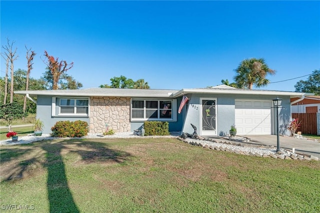 single story home featuring a front lawn and a garage