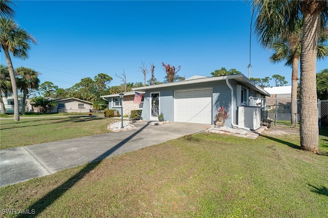 view of front of home with a front lawn, central AC, and a garage