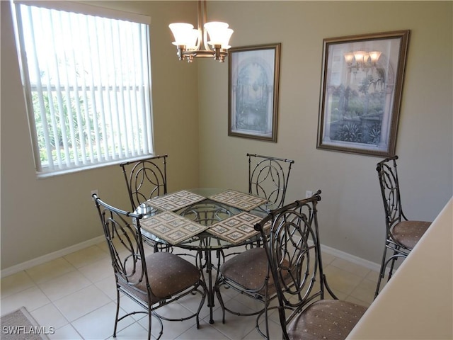 dining room with light tile patterned flooring and an inviting chandelier