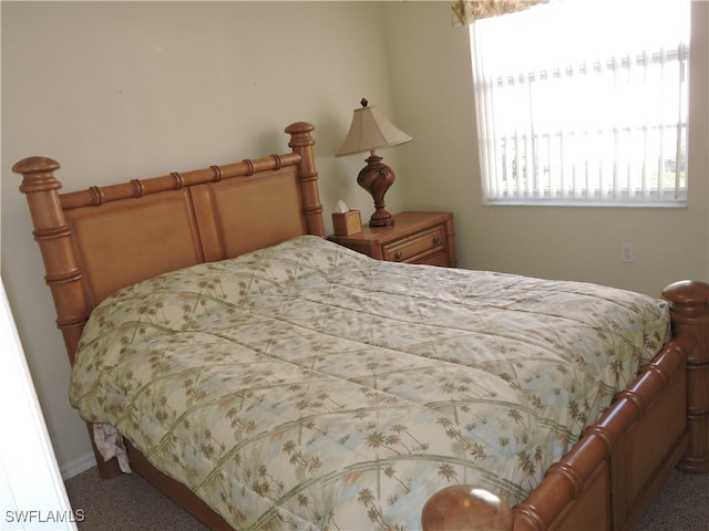 carpeted bedroom featuring multiple windows