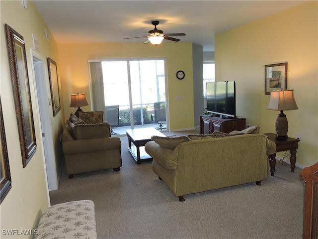 carpeted living room with ceiling fan