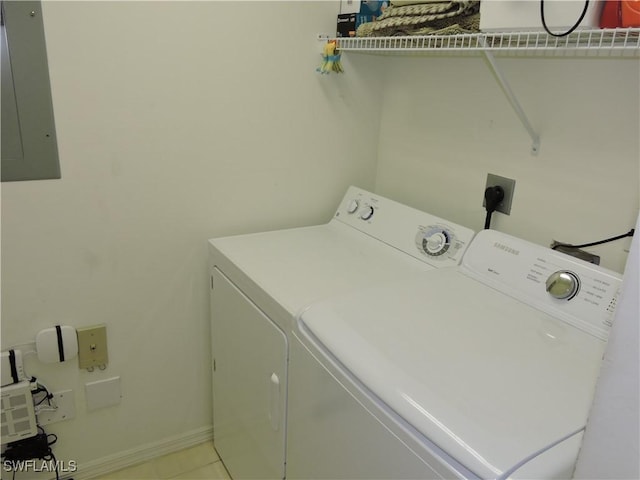 clothes washing area with washing machine and clothes dryer and electric panel