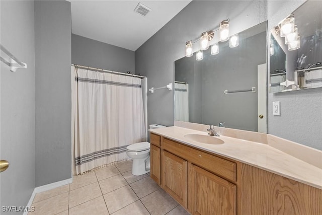 bathroom with vanity, tile patterned floors, and toilet