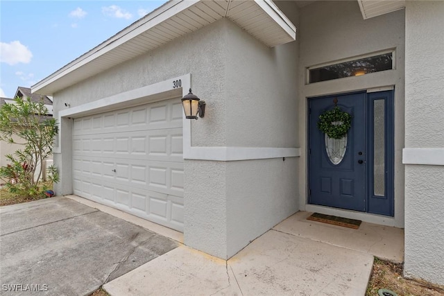 doorway to property featuring a garage