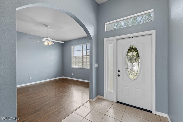 tiled entryway with ceiling fan