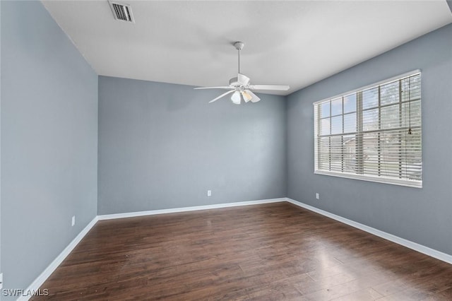 spare room with ceiling fan and dark hardwood / wood-style floors