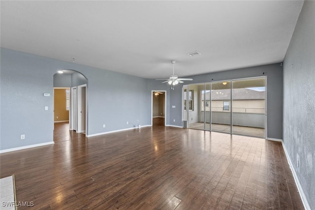 empty room with ceiling fan and dark hardwood / wood-style floors