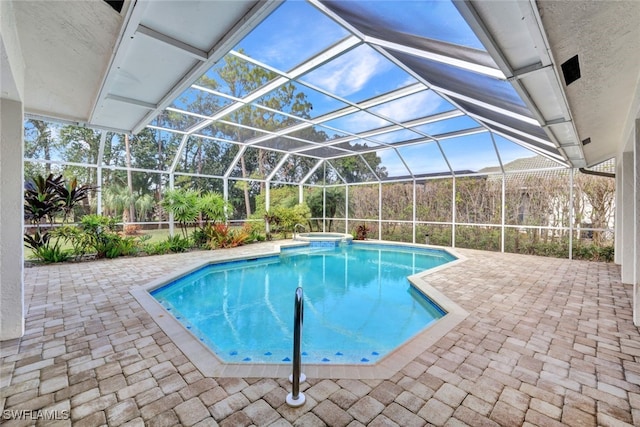 view of pool featuring a patio, a lanai, and a pool with connected hot tub