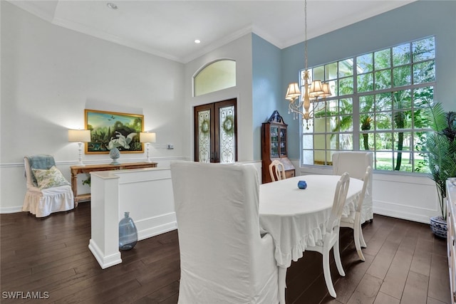 dining area featuring a healthy amount of sunlight, ornamental molding, and dark wood-type flooring