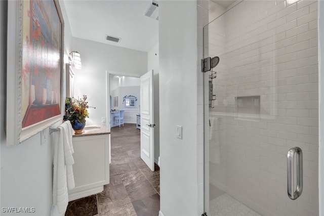 full bath with vanity, a shower stall, and visible vents