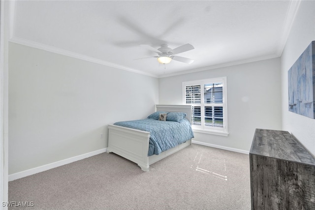 carpeted bedroom featuring ornamental molding, baseboards, and a ceiling fan