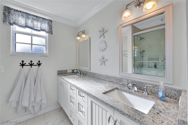 full bath featuring marble finish floor, crown molding, a sink, and a stall shower