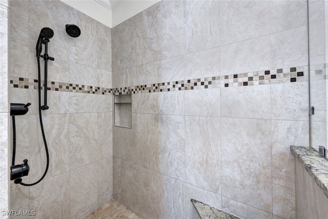 bathroom with a tile shower