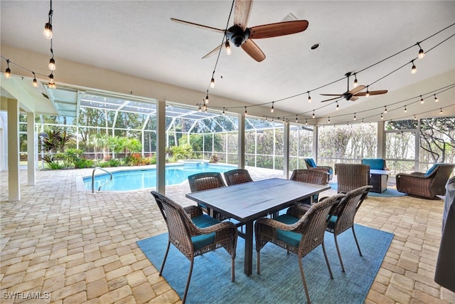 sunroom / solarium featuring plenty of natural light and a ceiling fan