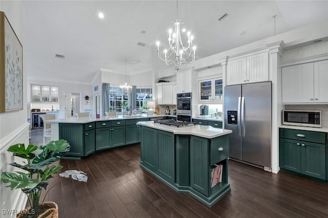 kitchen featuring a chandelier, stainless steel appliances, a kitchen island, green cabinets, and light countertops