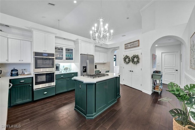 kitchen featuring appliances with stainless steel finishes, dark wood-type flooring, light countertops, white cabinetry, and green cabinetry