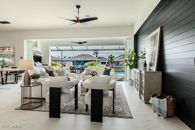 living room with wood walls and ceiling fan