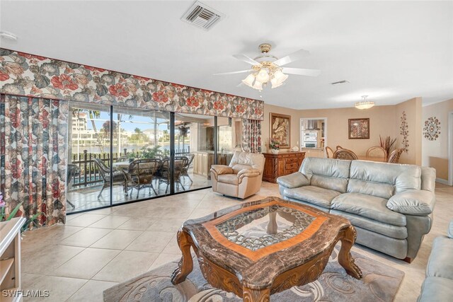 living room featuring ceiling fan and light tile patterned floors