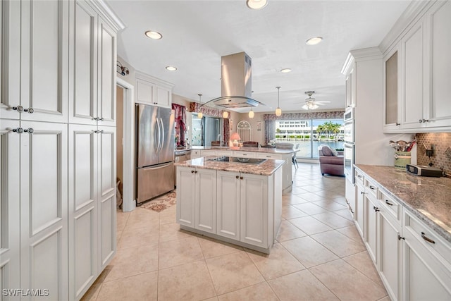 kitchen featuring stainless steel fridge, a center island, white cabinets, and island range hood