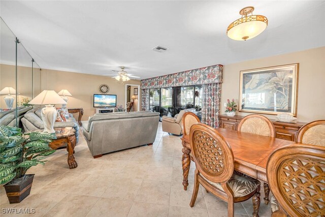 tiled dining space featuring ceiling fan