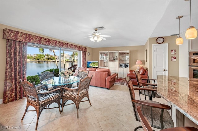 tiled dining space with ceiling fan