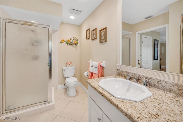 bathroom with tile patterned floors, vanity, toilet, and walk in shower