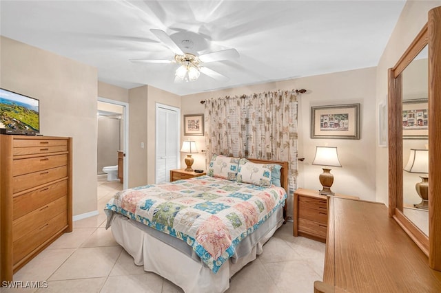 bedroom with ensuite bath, ceiling fan, a closet, and light tile patterned floors