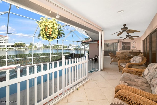 balcony featuring ceiling fan, a water view, and a patio