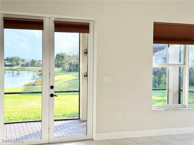 5161 Vizcaya St, Ave Maria, FL 34142 - entryway with a water view, baseboards, tile patterned floors, and french doors