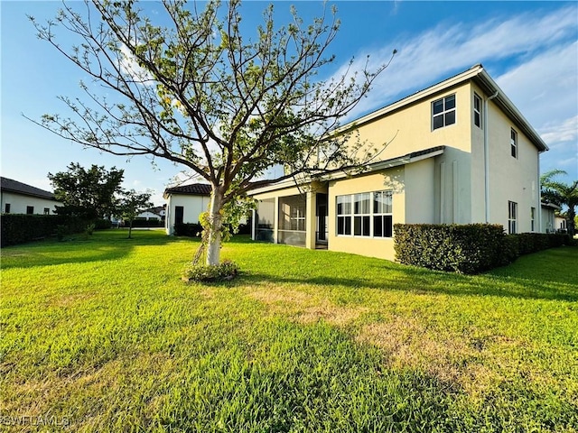 5161 Vizcaya St, Ave Maria, FL 34142 - back of property with stucco siding and a lawn