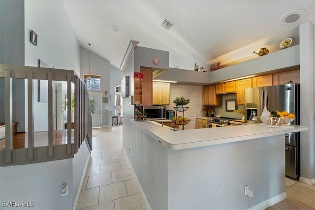 kitchen featuring high vaulted ceiling, backsplash, light tile patterned floors, and kitchen peninsula