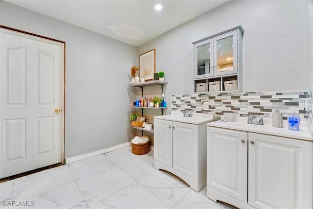 bathroom with decorative backsplash and vanity