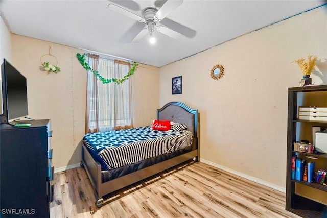 bedroom with ceiling fan and light hardwood / wood-style flooring