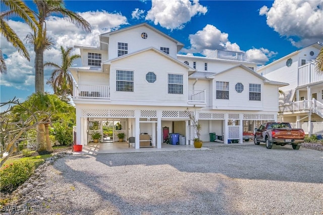 view of front of property featuring a balcony and a carport