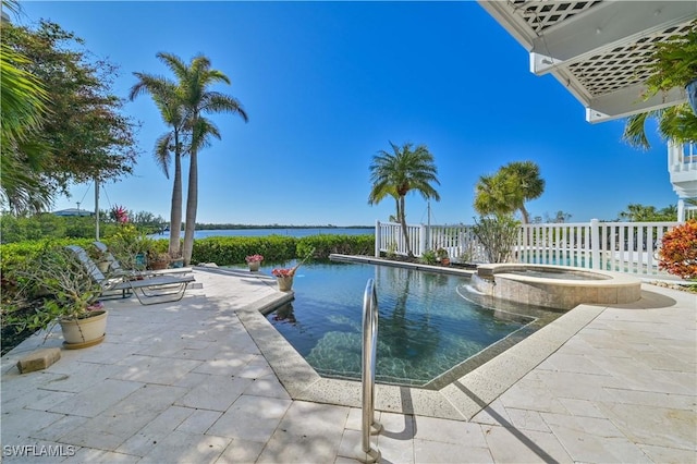 view of pool with a water view, an in ground hot tub, and a patio