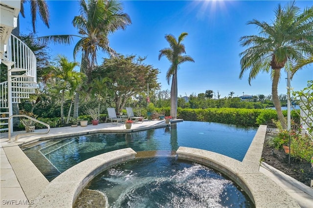 view of pool featuring an in ground hot tub and a patio area